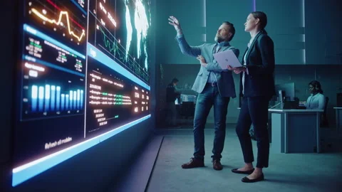 Two Computer Data Science Engineers Work with Laptop in Control Stock Footage 135970683