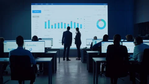 Two Computer Data Science Engineers Talk Next to Big Screen Stock Footage 136101228