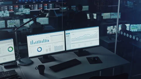 Two Computer Displays with Finance Charts and Data Stock Footage 136592767