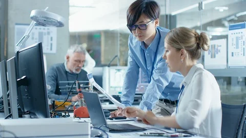 Two Computer Engineers Work with Documents. Stock Footage 85769408