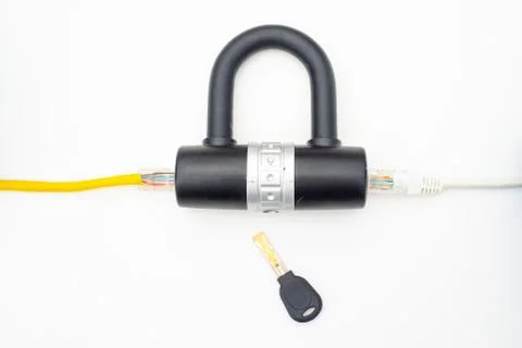 Two computer network cables going through a lock with a key Stock Photos
