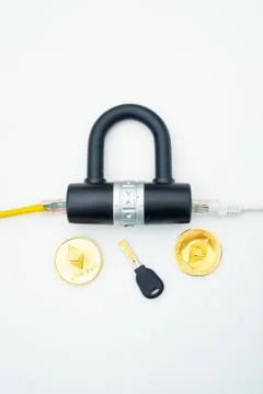 Two computer network cables going through a lock with a key and a crypto Foto stock