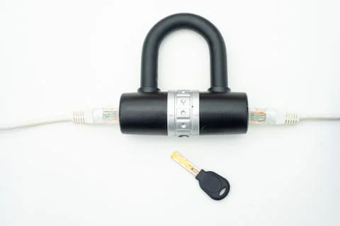 Two computer network cables going through a lock with a key Fotos Stock