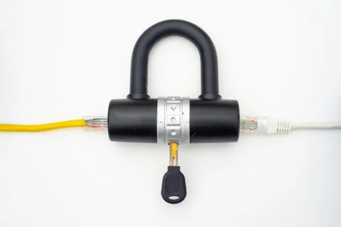 Two computer network cables going through a lock with a key 库存照片
