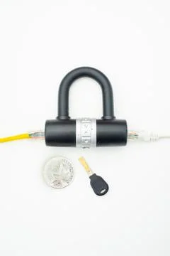 Two computer network cables going through a lock with a key and a crypto Photos