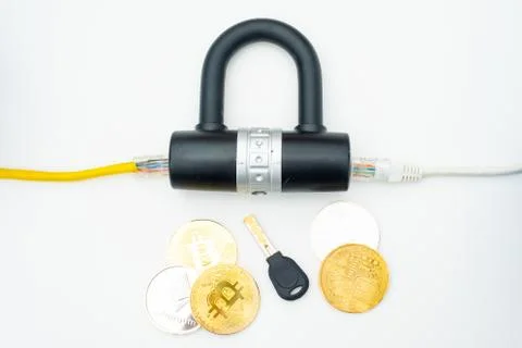 Two computer network cables going through a lock with a key and a crypto Stock-Fotos