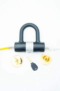 Two computer network cables going through a lock with a key and a crypto Stock-Fotos