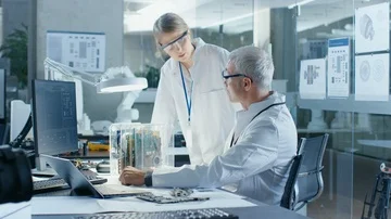 Two Computer Scientists Choose Between Printed Circuit Board to Work With. Stock Footage 85769839