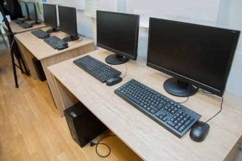 Two computers and a desk . Keyboard and mouse . Two computer monitors with a  Stock Photos