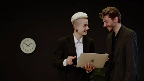 Two confident business people using laptop for project presentation. Executive Stock Footage 257093171