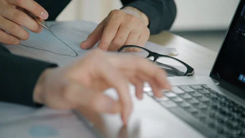 Two confident businessmen cooperating on project, sitting at table with laptop Stock Footage 90230394