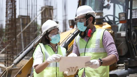 Two confident engineers discussing  on building construction site. Stock-Footage 162020200