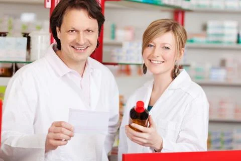 Two confident pharmacists at work Stock Photos