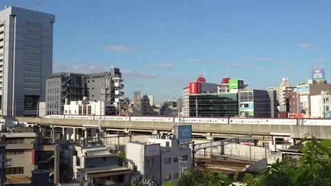 Two Connected Shinkansen Bullet Trains Drive Through The City Center of Tokyo Stock Footage 269153812