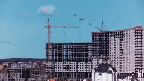 Two construction cranes are working at a construction site Stock Footage 142061149