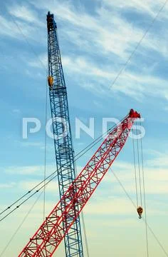 Two construction cranes over blue sky Stock Photos