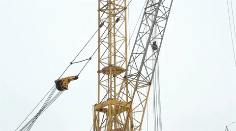 Two construction cranes working on a construction site Stock Footage 65286266