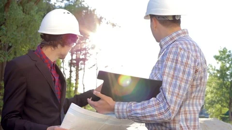 Two construction engineers on the construction site inspect the drawings Stock Footage 76641878