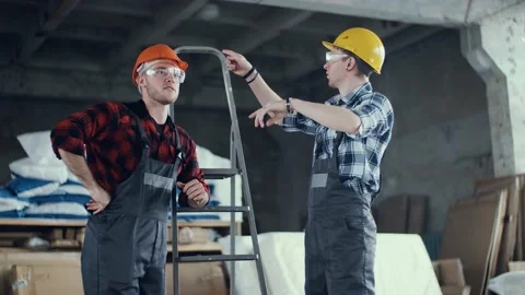Two construction engineers inspecting the place of work, planning to start a new Stock Footage 136356849