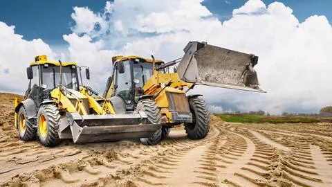 Two construction loaders are ready to go to work at a construction site, an.. Stock-Fotos