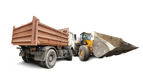 Two construction vehicles, a dump truck and a loader, are isolated on a white Stock Photos