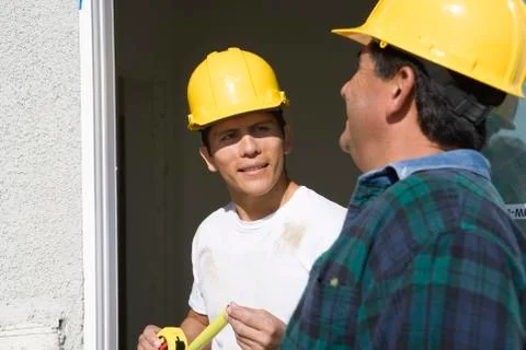 Two Construction Workers Checking Window Stock Photos