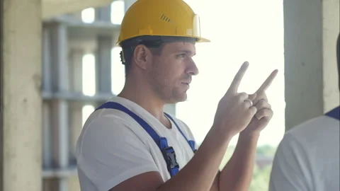 Two construction workers discussing project Stock Footage 121935974