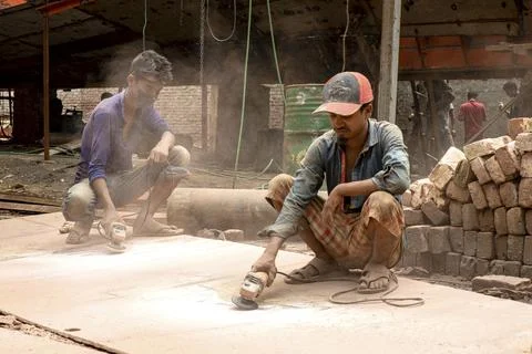 Two Construction Workers Grinding Stone Slabs On Site Stock Photos