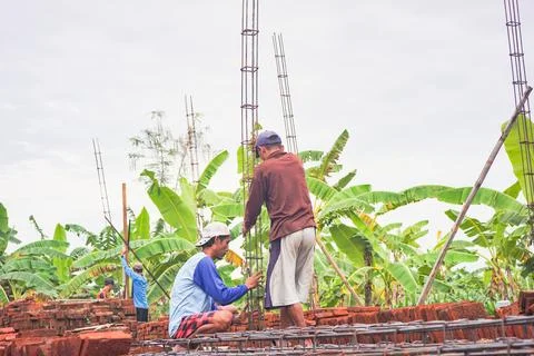 Two construction workers install cast iron to build the walls. house construc Stock Photos
