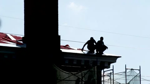 Two construction workers metal roof on edge. Russia - 22 September 2026 Stock Footage 341833439