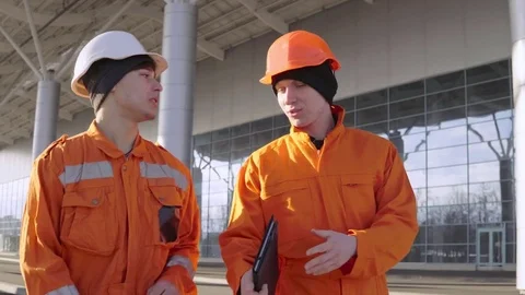 Two construction workers in orange unifo... | Stock Video | Pond5