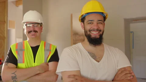 Two Construction Workers Proudly Posing Together Inside a Newly Renovated Stock Footage 306343401