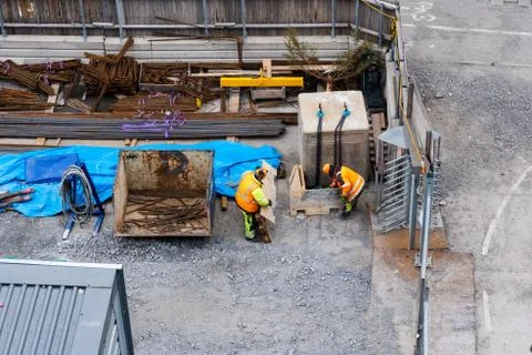 Two construction workers at the sites storage area searching for material, St Foto stock