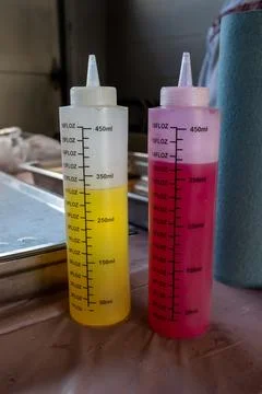 Two container with the primary colors of red and yellow used to dye yarn Foto stock