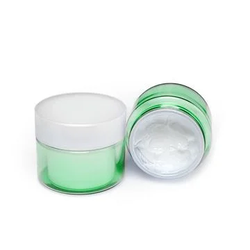 Two containers of moisturizing face cream on white background. Stock Photos