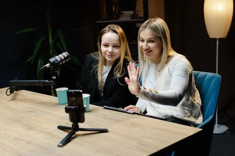 Two Content Creators Waving at Camera During Live Podcast Recording Stock Photos