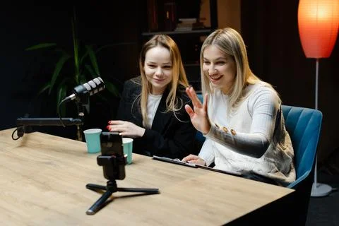 Two Content Creators Waving at Camera During Live Podcast Recording Stock Photos