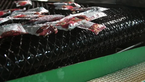 Two conveyor lines on a tomato processing factory with falling ketchup packages Stock Footage 118352704