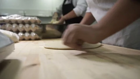 Two cookers work with dough on board in industrial kitchen setting Stock Footage 71536951