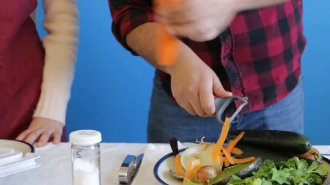 Two cooking students learning to use mandolin slicer Stock Footage 124664796