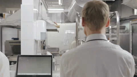 Two cooks with digital tablet over restaurant kitchen background Stock Footage 125051316