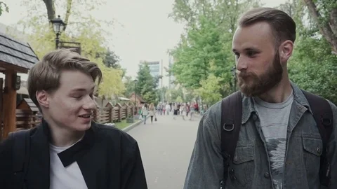 Two cool young men walking across Shibuya crossing In tokyo Japan tourists . Stock Footage 81039200
