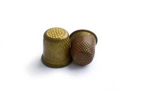 Two copper antique thimbles isolated on a white background with a shadow. Stock Illustration