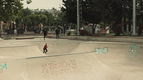 Two cops chasing a suspect through a skate park Stock Footage 283064642