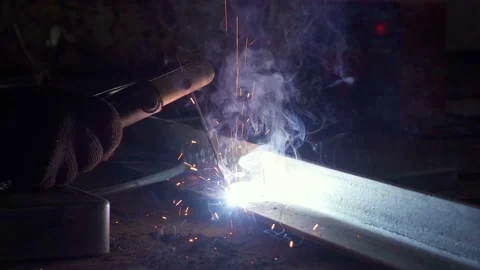 Two corners are welded with electrode welding Stock Footage 155449061