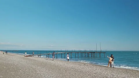 Two couple walking on the beach Stock Footage 168300026