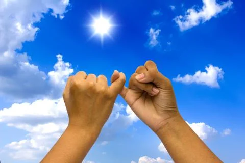 Two coupled hands on blue sky. Stock Photos
