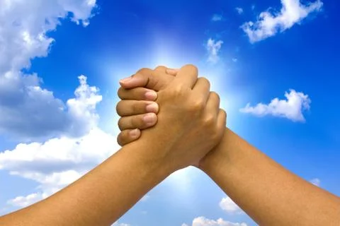 Two coupled hands, on sky. Stock Photos