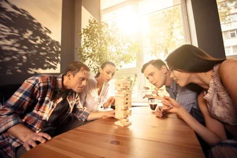 Two couples are playing Jenga Stock Photos