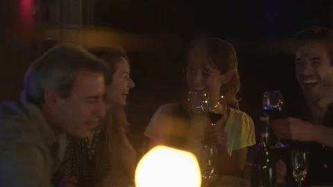 Two couples enjoying outdoor dinner party Stock Footage 75170989